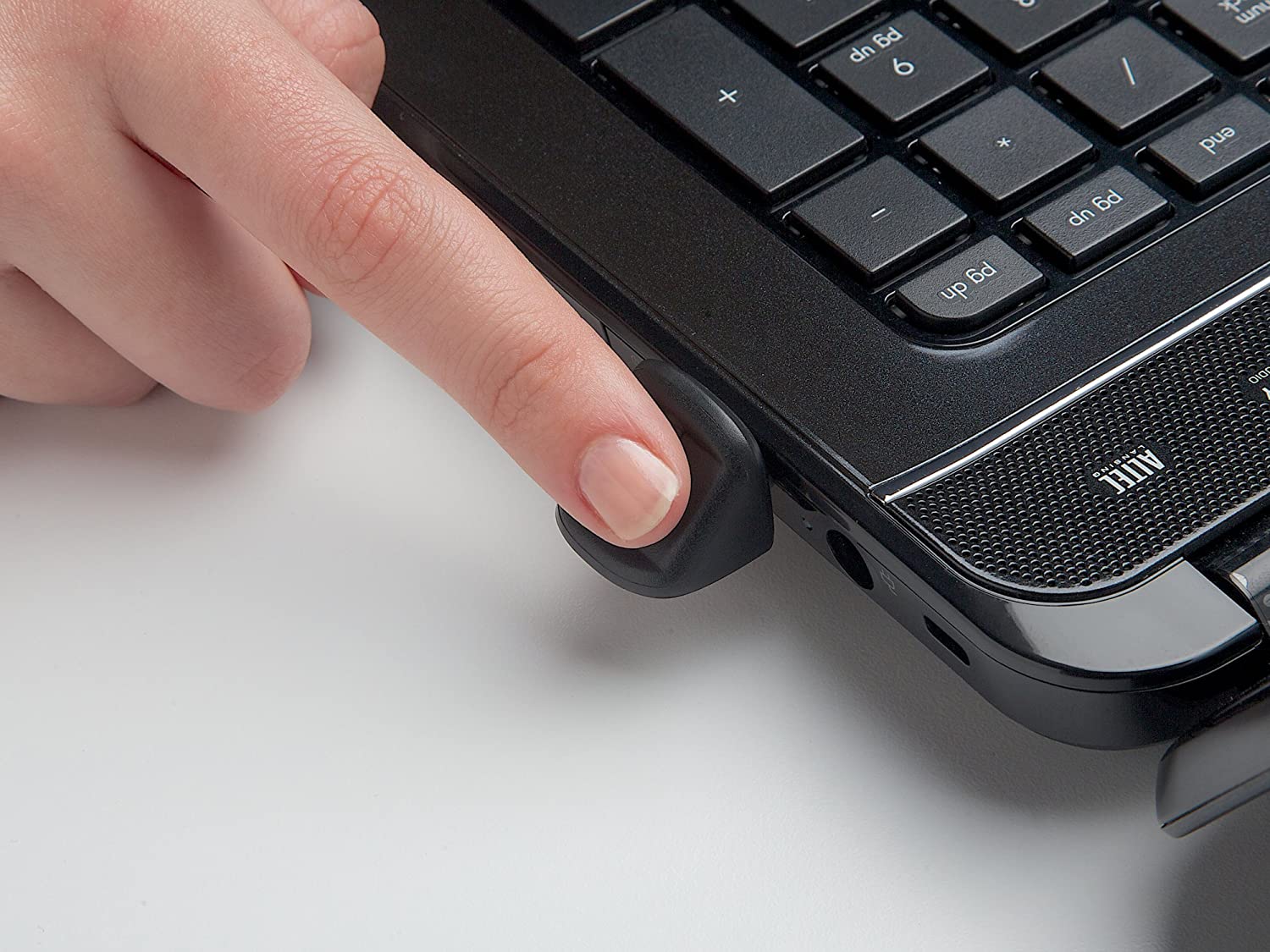 Finger using a fingerprint scanner on laptop.